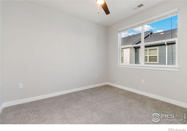 unfurnished room featuring ceiling fan and carpet floors