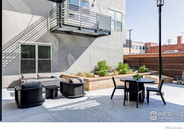 view of patio / terrace with a balcony and an outdoor hangout area