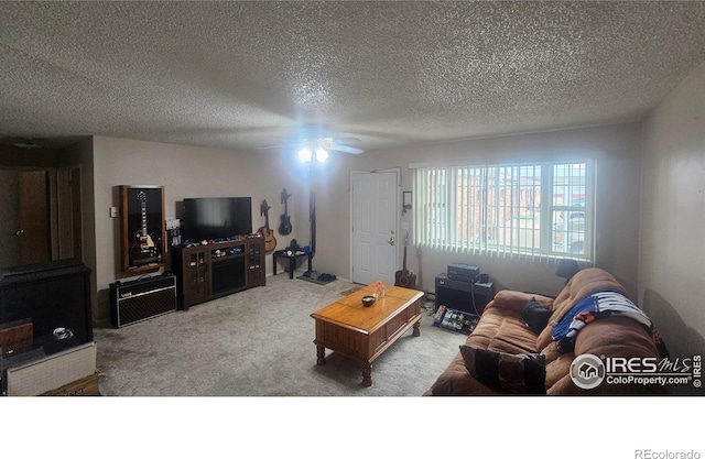 carpeted living room with ceiling fan and a textured ceiling