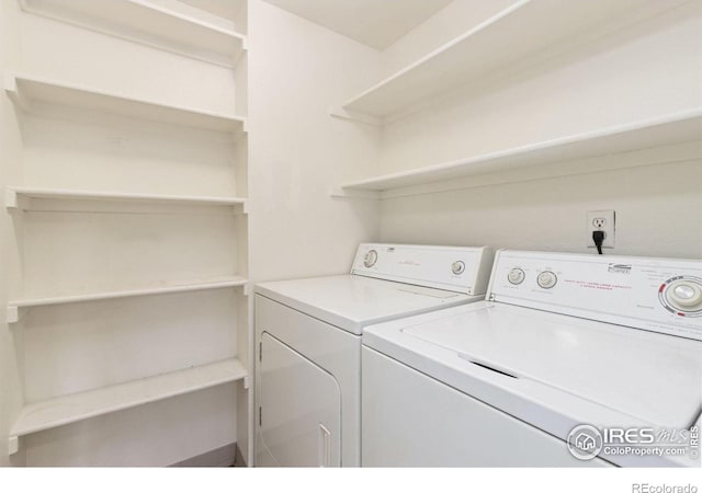 clothes washing area featuring independent washer and dryer