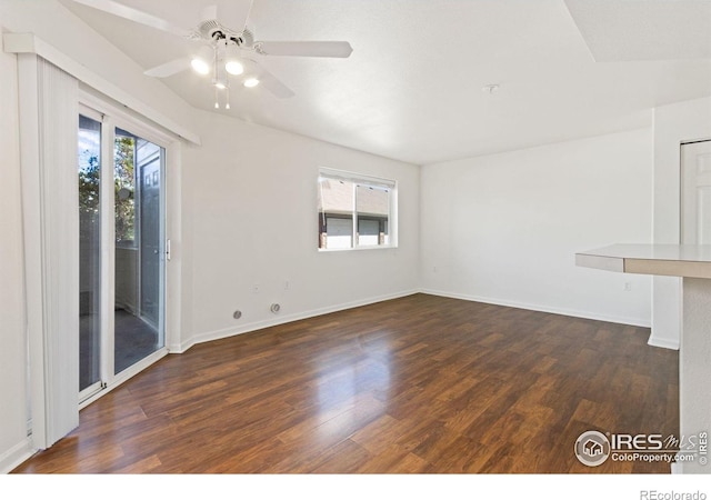 empty room featuring ceiling fan and dark hardwood / wood-style flooring