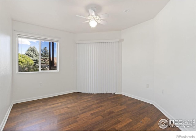 empty room featuring ceiling fan and dark hardwood / wood-style flooring