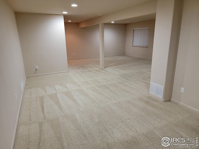 basement featuring light colored carpet