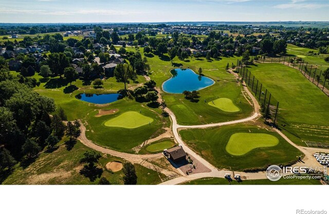 bird's eye view featuring golf course view and a water view