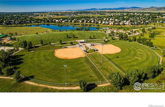 birds eye view of property with a water and mountain view