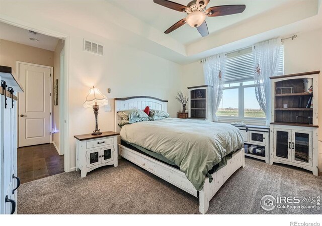 bedroom with ceiling fan and dark hardwood / wood-style floors