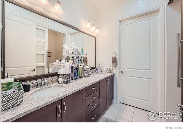 bathroom featuring tile patterned flooring and vanity