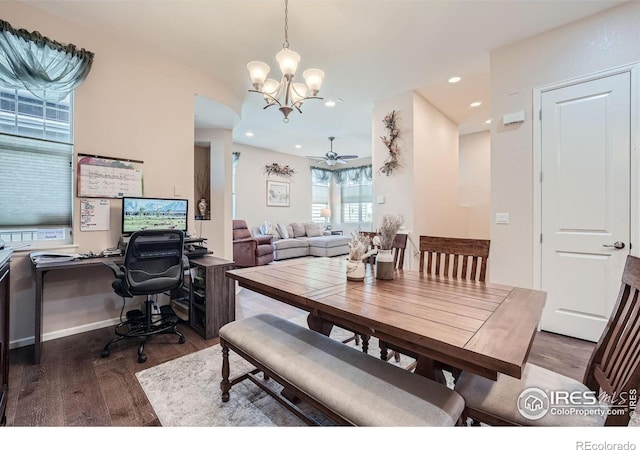 dining room with ceiling fan with notable chandelier and dark hardwood / wood-style floors