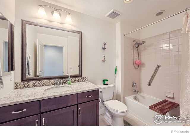 full bathroom featuring toilet, vanity, and shower / bathtub combination with curtain