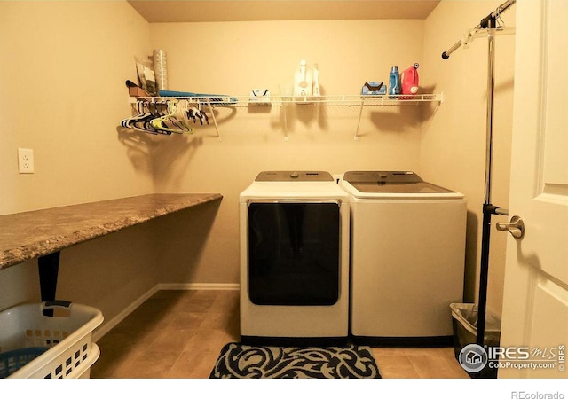 laundry room featuring separate washer and dryer and tile patterned flooring