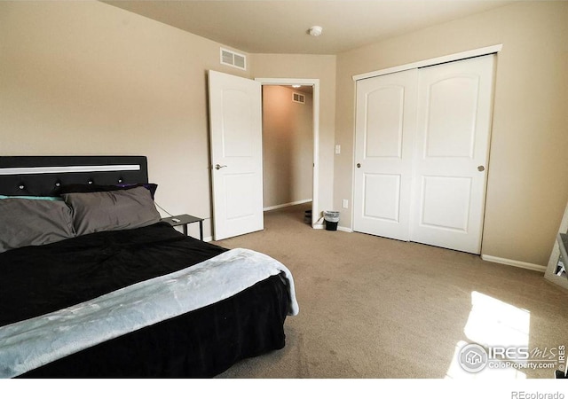 bedroom featuring a closet and light carpet