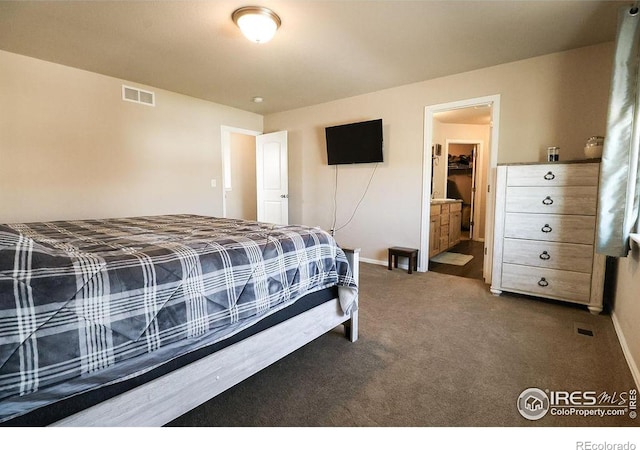 carpeted bedroom featuring connected bathroom