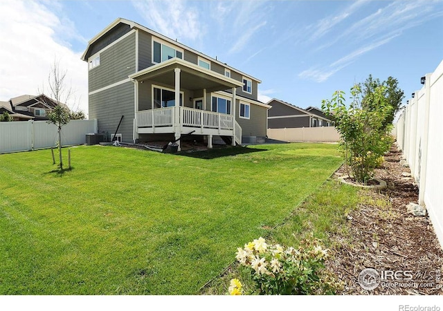 back of property featuring a lawn and cooling unit