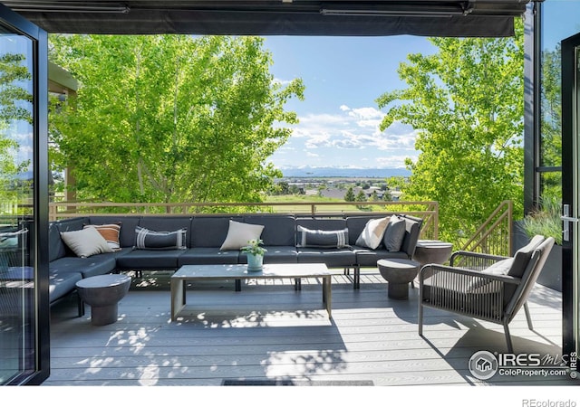 wooden terrace with an outdoor hangout area