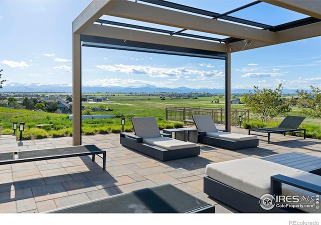 view of patio / terrace with a mountain view and a rural view