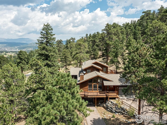 back of house with a deck with mountain view