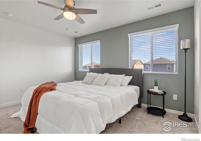 bedroom featuring light colored carpet and ceiling fan