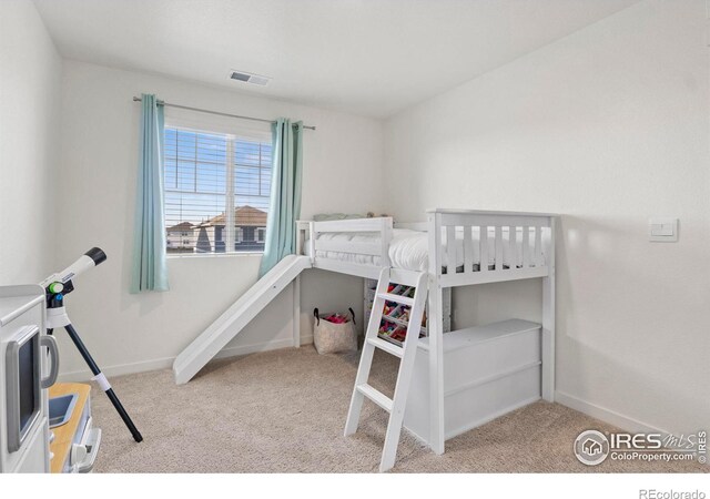 bedroom featuring light colored carpet