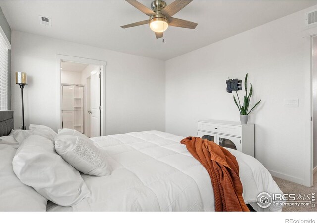 carpeted bedroom with ceiling fan and ensuite bathroom