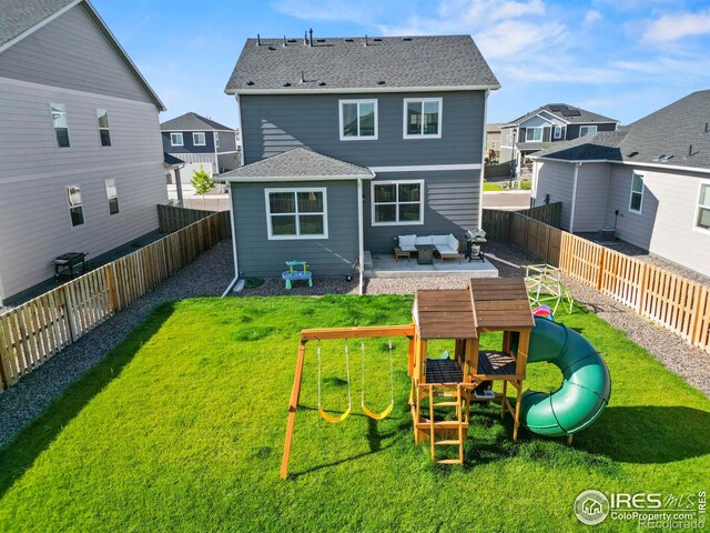 rear view of house with a playground, outdoor lounge area, a patio area, and a yard