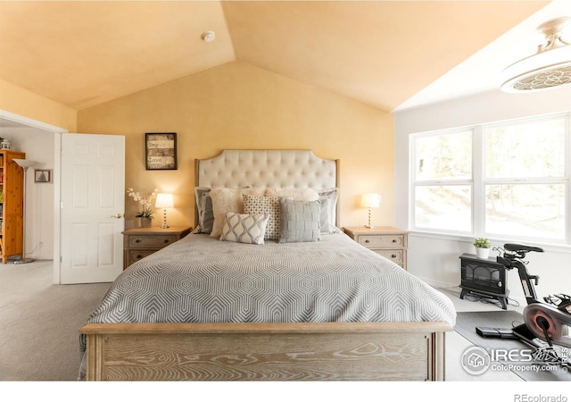 carpeted bedroom with lofted ceiling