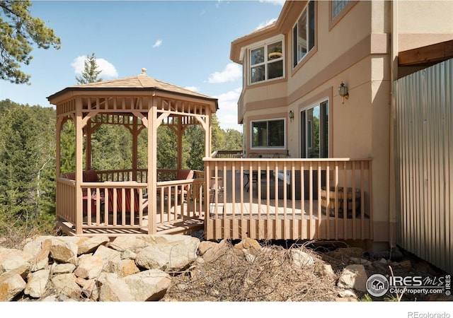 wooden deck featuring a gazebo