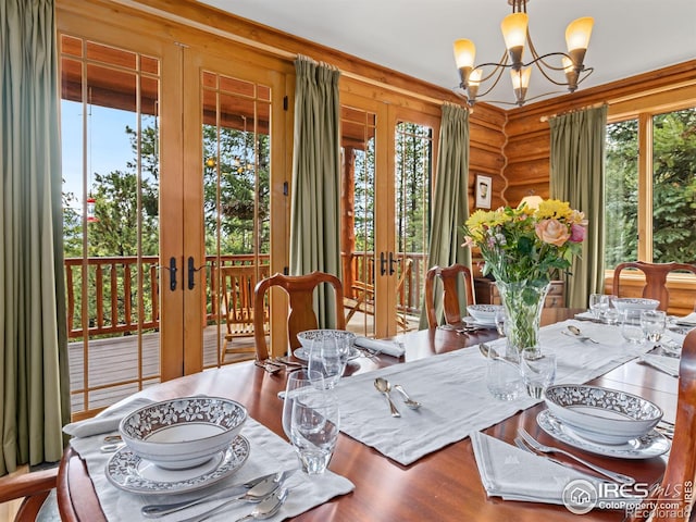 dining space featuring a notable chandelier, plenty of natural light, and french doors