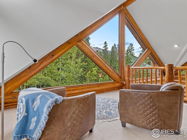 interior space with light carpet and vaulted ceiling