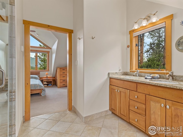 ensuite bathroom featuring tile patterned flooring, double vanity, an enclosed shower, and high vaulted ceiling