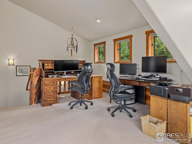 home office with light carpet and lofted ceiling