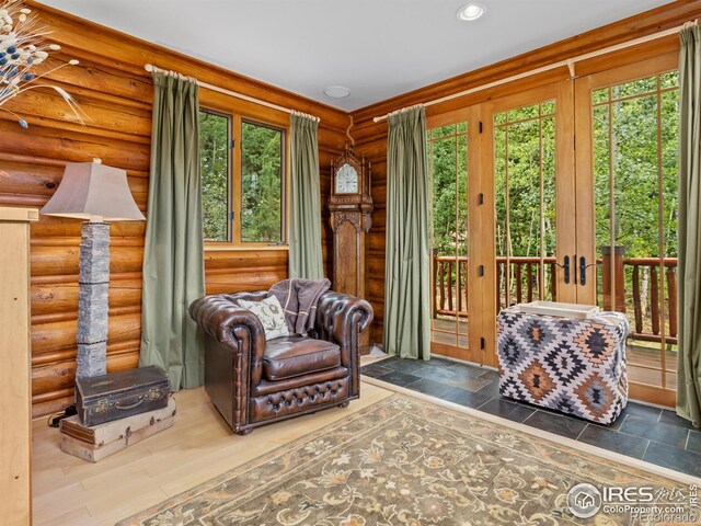 sunroom / solarium with healthy amount of natural light and french doors