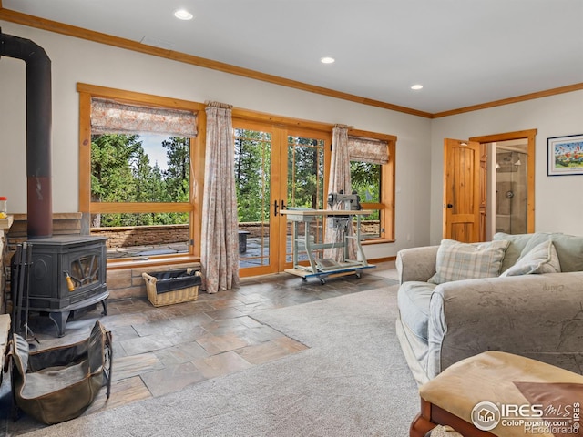 living room with french doors, a wood stove, and ornamental molding