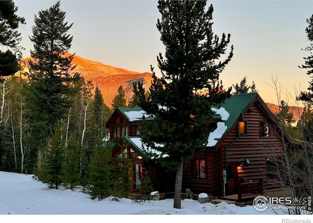 snow covered property featuring a mountain view