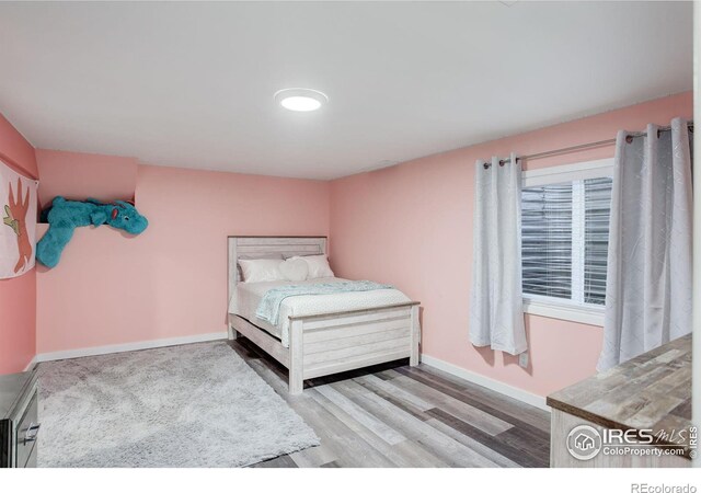 bedroom with light hardwood / wood-style flooring