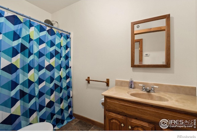 bathroom with vanity, toilet, curtained shower, and tile patterned floors