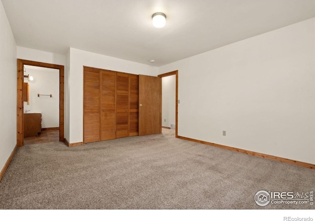 unfurnished bedroom featuring a closet and light carpet