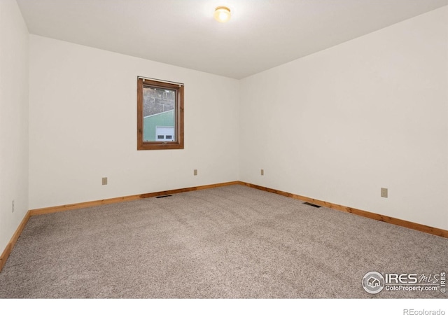 unfurnished room with light colored carpet