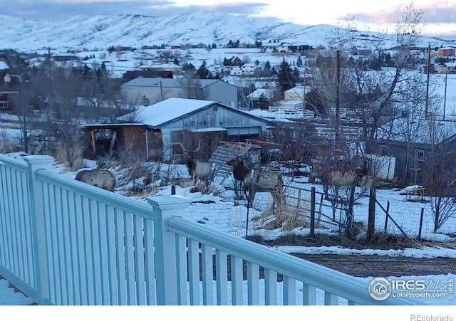 snowy yard with a mountain view