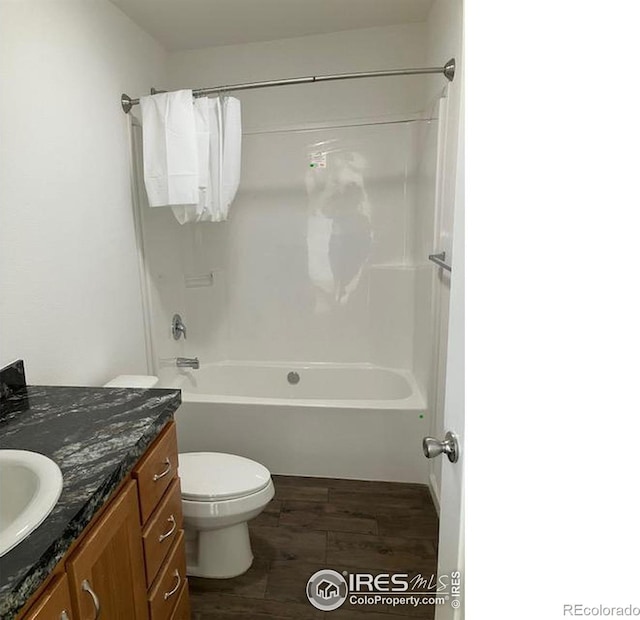 full bathroom with toilet, vanity, bathing tub / shower combination, and wood finished floors