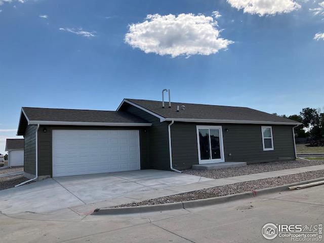 single story home featuring an attached garage and driveway