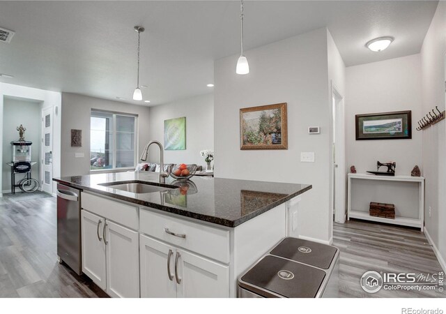 kitchen featuring hanging light fixtures, white cabinets, and light hardwood / wood-style floors