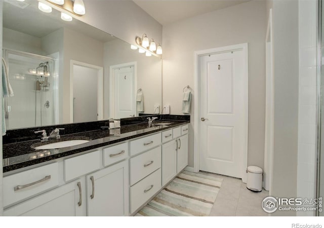 bathroom with vanity, an enclosed shower, and tile patterned floors