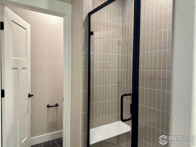 bathroom with a shower with door