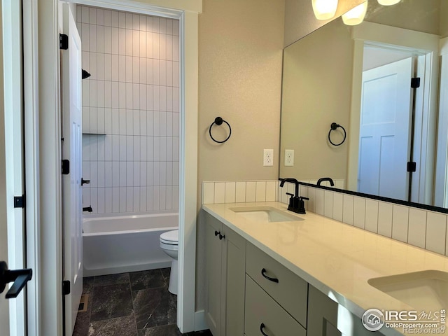 full bathroom featuring toilet, vanity, and tiled shower / bath combo