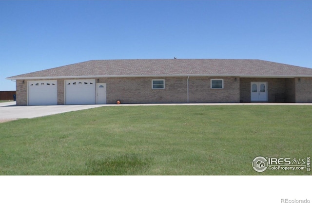 ranch-style house featuring brick siding, concrete driveway, and a front yard