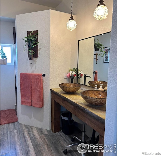 full bathroom featuring a sink and wood finished floors