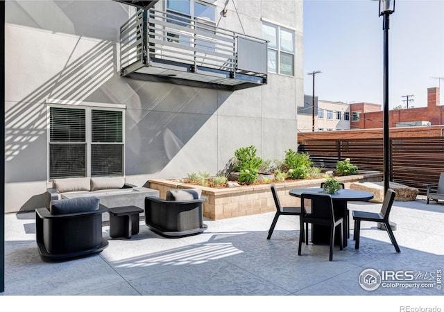 view of patio / terrace with an outdoor hangout area, outdoor dining area, and a balcony