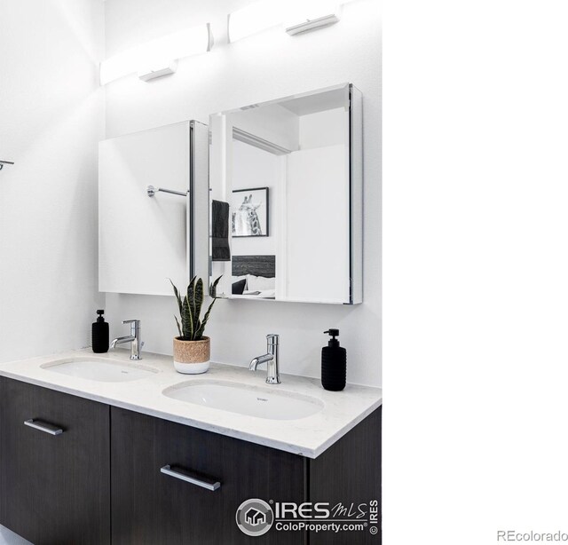 full bath featuring double vanity and a sink