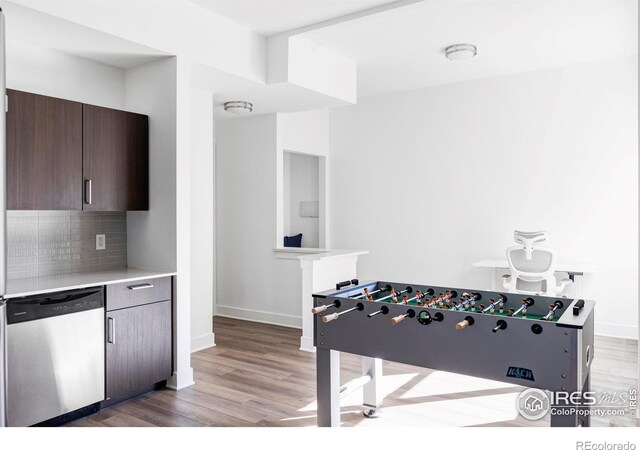 playroom featuring light wood-type flooring and baseboards