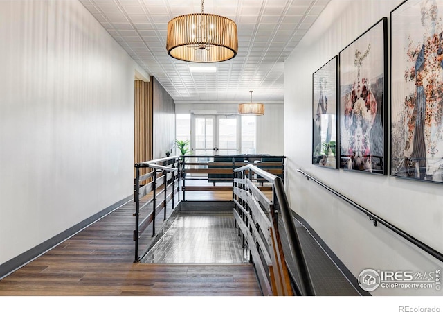 interior space featuring pendant lighting, a chandelier, and dark hardwood / wood-style floors